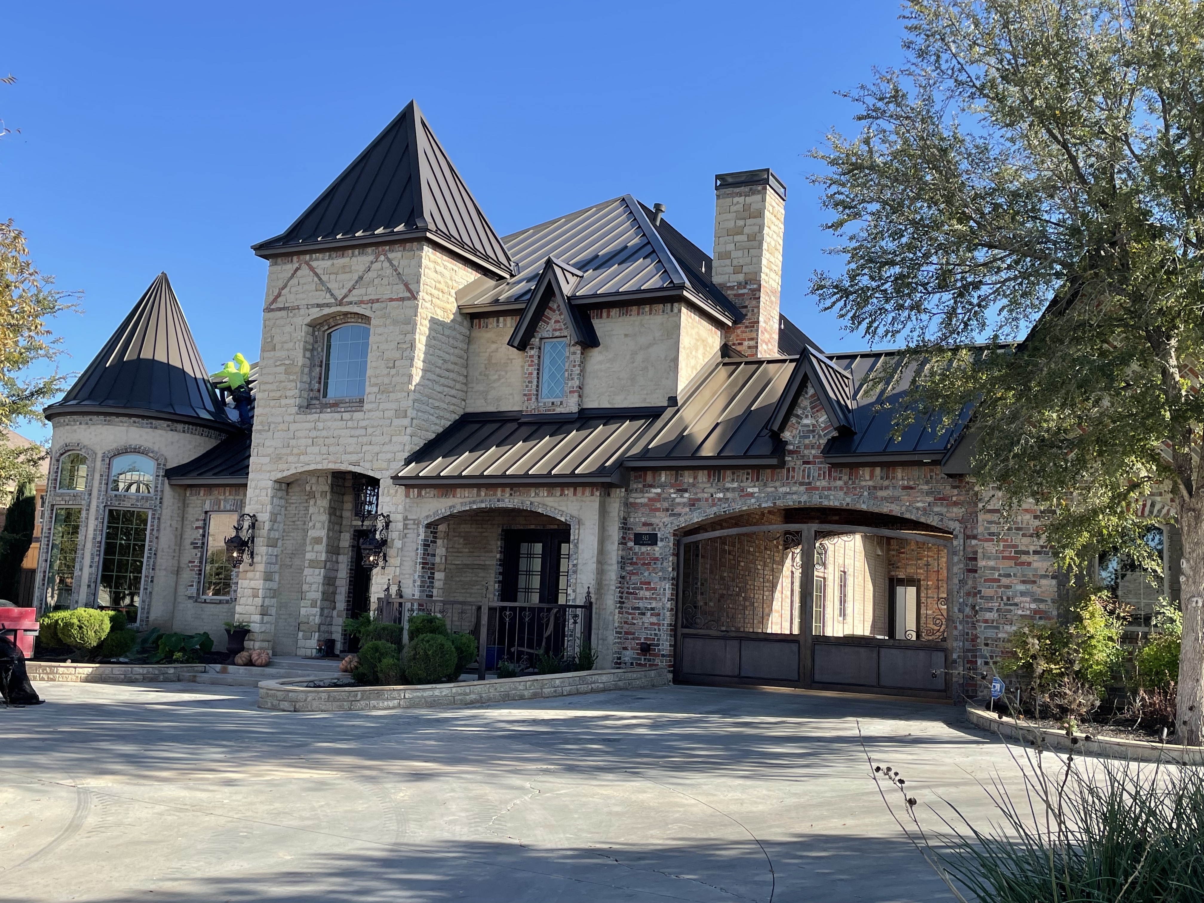 Custom castle estate with standing seam metal roofing by Metaluxe